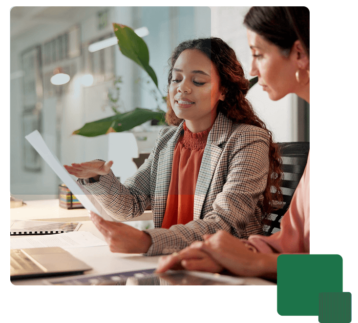 two female professionals reviewing data integration report